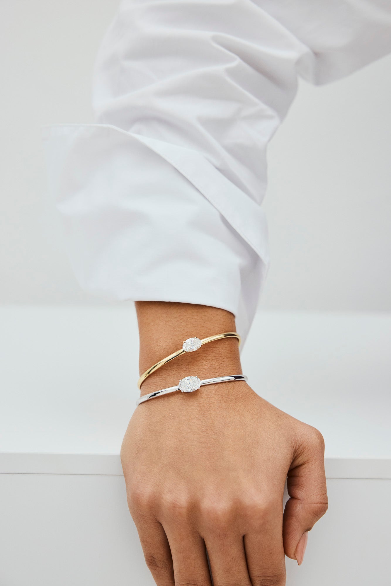 Close-up of a woman wearing two lab-grown diamond bracelets