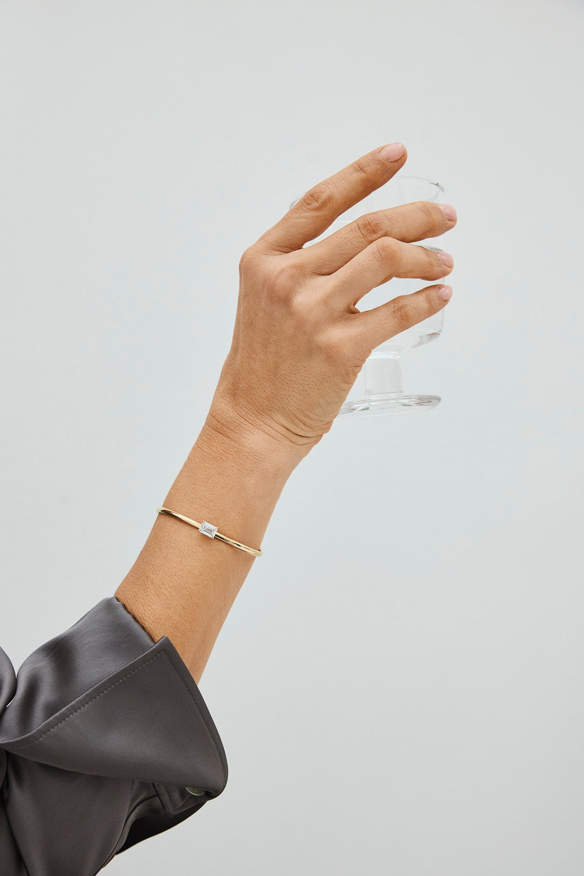 Woman wearing a gold bracelet with square lab-grown diamonds