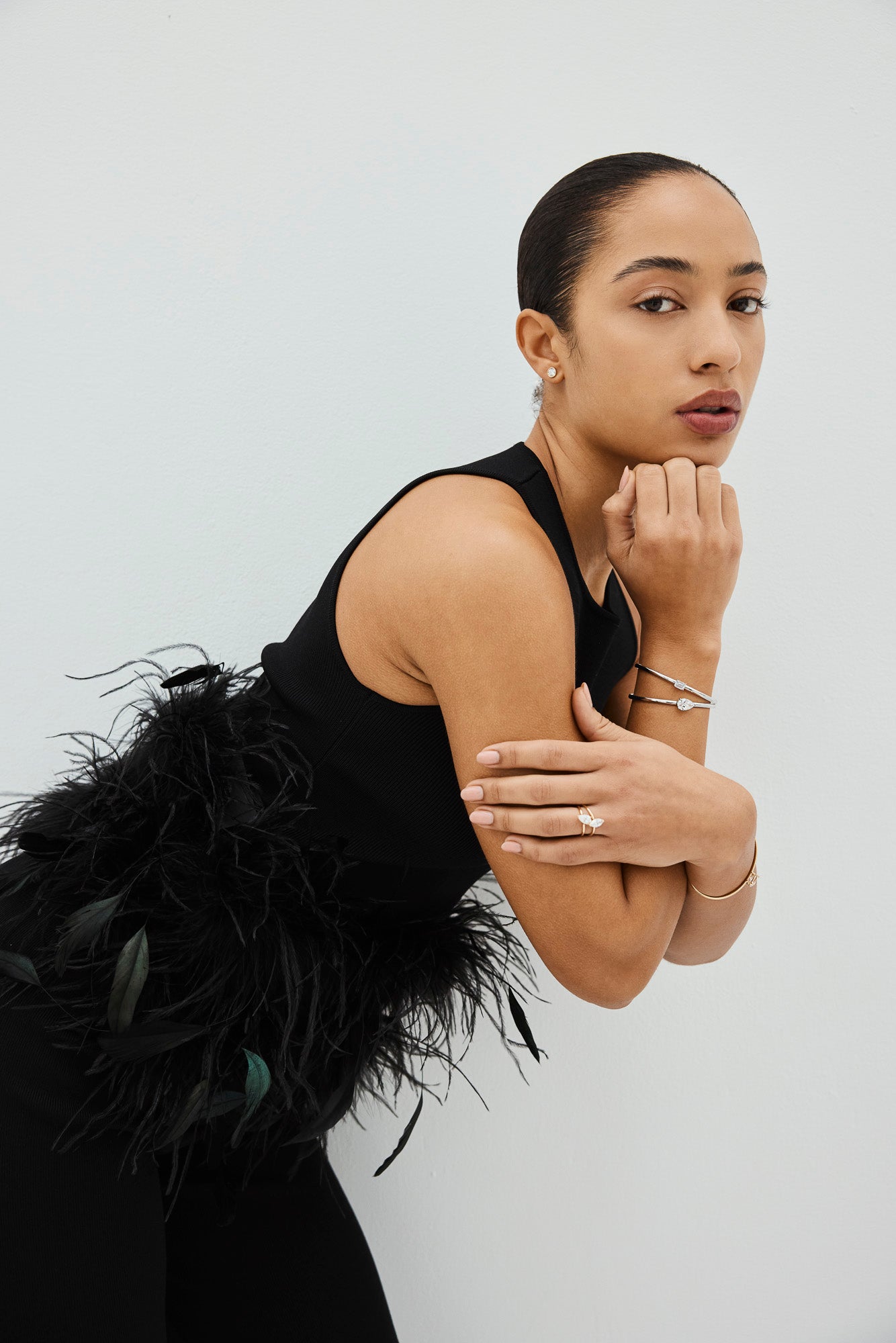 Woman wearing lab-grown diamond rings, bracelet, and stud earrings