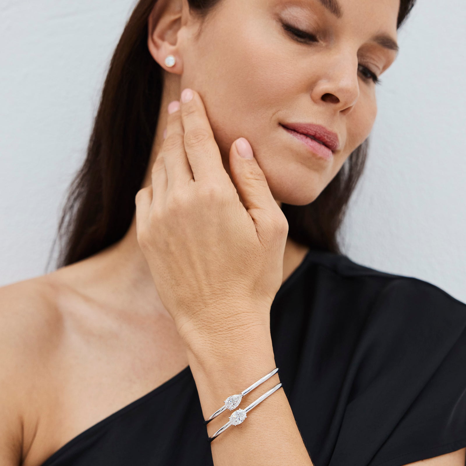 Close-up of two lab-grown diamond bracelets worn on a hand